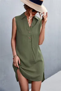 Detail showing the V-neck button closure and cotton linen texture of the green sleeveless dress