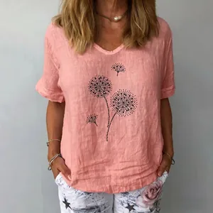 Detail view of loose peach cotton linen top with artistic black dandelion dot print.