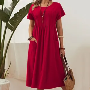 Detailed view of pleated chest and pockets on red cotton linen short sleeve midi dress