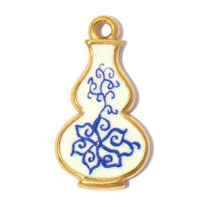 Close-up of gourd vase pendant with blue floral enamel on gold stainless steel.