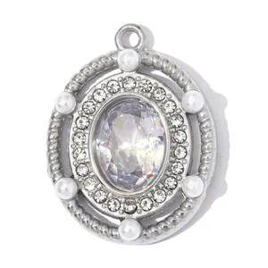 Macro view of a stainless steel pendant featuring a large oval zircon and pearls.
