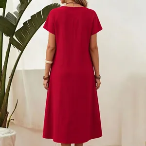 Back view detail of a solid red short-sleeved cotton linen midi dress with round neck.