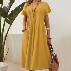 Detail of mustard yellow cotton linen dress with pleated bodice and pockets