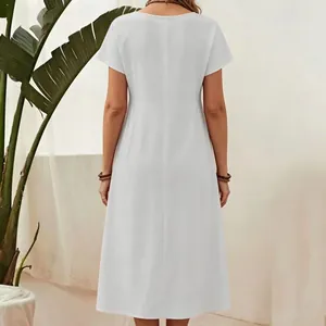Rear view detail of a white cotton linen midi dress featuring a minimalist round neck design