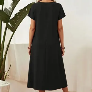 Back view of a minimalist black short-sleeved cotton-linen maxi dress with round neck detail