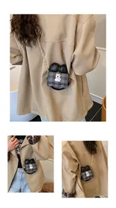 Detailed view of a cute mini crossbody bag with a bow and cartoon patch on model