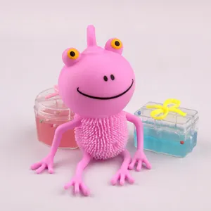 Pink cartoon frog squeeze toy with textured belly shown alongside colorful toy boxes