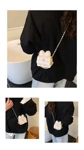 Mini crossbody bag with cartoon dog and bow detail worn by a model