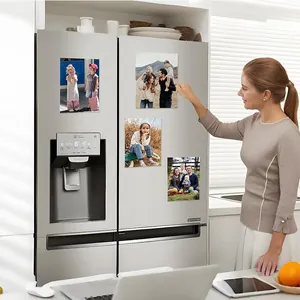 Transparent acrylic magnetic photo frames displayed on a modern stainless steel refrigerator