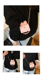 Detailed view of the cute pink cartoon bow crossbody bag worn with a black sweater.