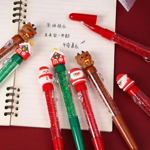 Close-up of Christmas gel pens with cute cartoon toppers and sparkling crystal barrels