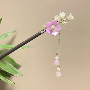 Elegant sandalwood hair stick with pink floral motifs and delicate tassels