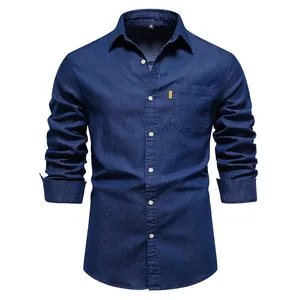 Detail of a dark blue long-sleeved denim shirt for men with a chest pocket and buttons.