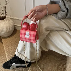 Cute pink plaid mini crossbody bag with a large red bow and cartoon dog