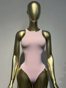 Front view of a light pink sleeveless slimming bodysuit displayed on a premium gold mannequin.