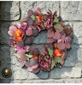 Autumn artificial wreath with peonies and hydrangeas on a stone wall background