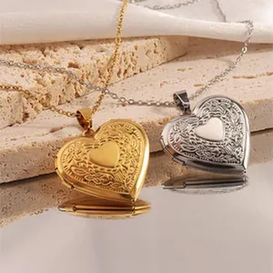Detail of two vintage engraved heart locket necklaces in gold and silver steel finishes.