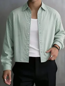 Detailed view of a men's green vertical striped long-sleeve shirt with a relaxed fit.
