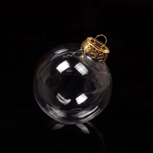 Close-up view of a clear plastic Christmas ornament ball with a detailed golden metal cap