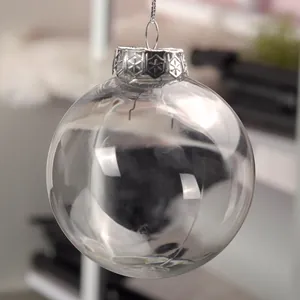 Detailed macro view of a clear plastic Christmas ornament ball with an ornate silver cap