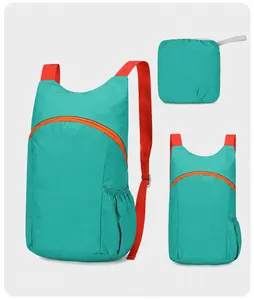 Teal lightweight foldable backpack with orange straps for hiking and travel