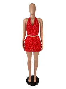Detail view of red polka dot halter top and layered ruffle mini skirt set on mannequin