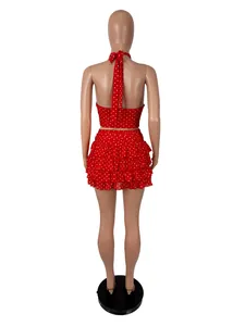 Detailed back view of a sexy red and white polka dot halter crop top and ruffled mini skirt