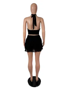 Professional rear view of a black halter neck crop top and ruffled mini skirt set.