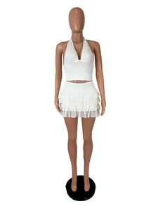 Detailed view of a white halter neck crop top paired with a tiered ruffled mini skirt set