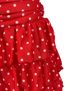 Close-up of red polka dot skirt featuring layered ruffle and lettuce edge details