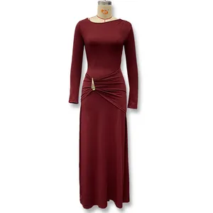 Elegant burgundy long-sleeved maxi dress with ruched waist and metal ornament detail