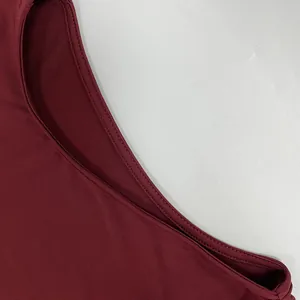 Close-up of fine stitching on the neckline of a wine red slim-fit long-sleeved dress.