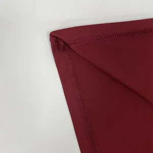 Close-up of wine red dress showing high-quality stitching and fabric texture detail
