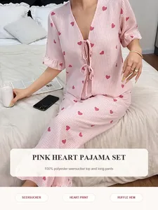 Detailed view of pink heart print seersucker pajama set with ruffle hem accents