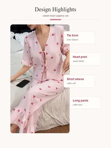 Detailed view of the sweet heart print pajama set featuring ruffle cuffs and a bow tie front