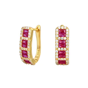 Detailed view of gold-plated S925 silver hoop earrings with red baguette cubic zirconia