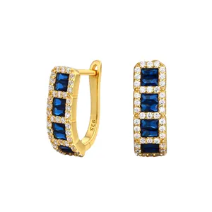 Detailed view of gold plated S925 sterling silver earrings with baguette blue cubic zirconia