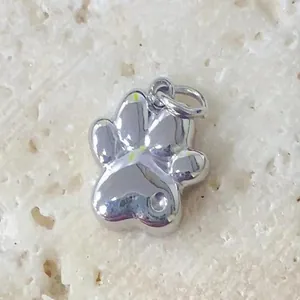 Close-up of polished stainless steel cat paw charm for DIY jewelry making projects