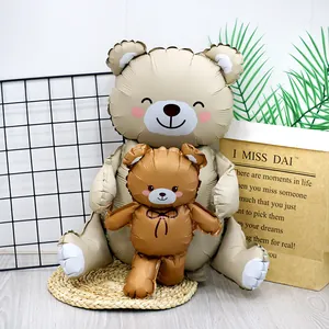 Scene showing two different sizes of standing teddy bear foil balloons for festive decor