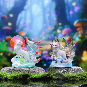 Detailed macro view of two iridescent nine-tailed fox figurines placed on mossy rocks