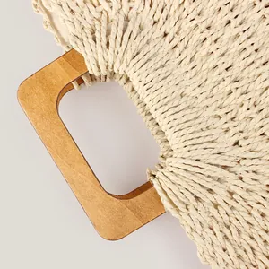 Handmade woven paper rope summer beach bag featuring minimalist wooden handle detail
