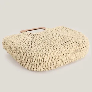 Minimalist handwoven beige paper rope summer beach bag with a stylish wooden handle