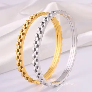 Polished gold and silver stainless steel bangles with elegant scalloped star pattern