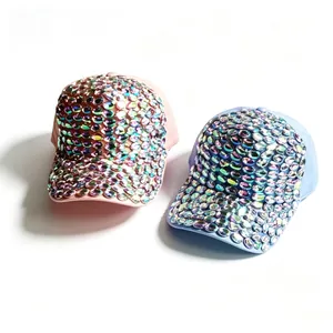 Detail shot of handmade sparkling iridescent rhinestone baseball caps in pink and blue