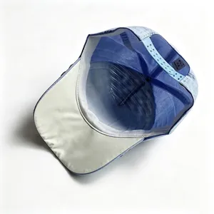 Detailed interior view of a blue denim baseball cap showing the adjustable snapback strap.