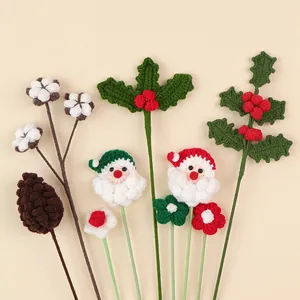 Detail of handmade crochet Christmas bouquet featuring Santa Claus and holly berries