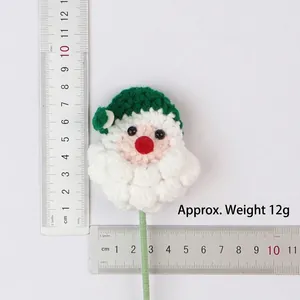 Detail view of handmade crochet Santa Claus flower ornament with weight and size measurements