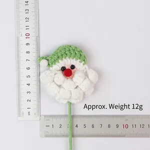 Detailed view of hand-knitted Santa Claus flower showing size and 12g weight.