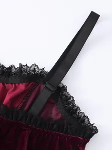 Close-up detail of dark red velvet camisole with black lace trim and adjustable strap