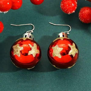 Detail view of festive red Christmas ball earrings with gold glitter stars